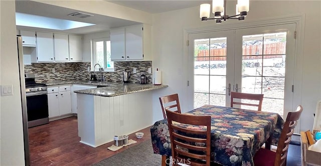 40022 172nd St E, Palmdale, CA 93591 - kitchen with stainless steel gas range oven, a sink, french doors, backsplash, and a chandelier