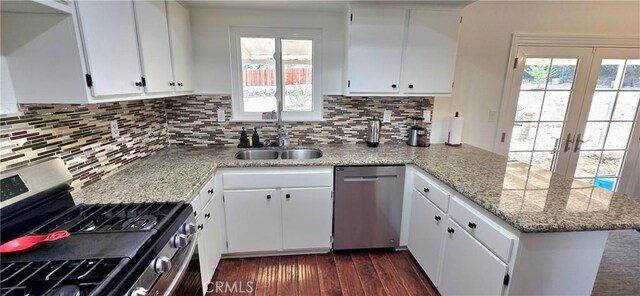 40022 172nd St E, Palmdale, CA 93591 - kitchen with stainless steel appliances, a peninsula, a sink, dark wood-style floors, and french doors