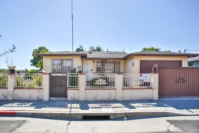 2851 Webster Ave, Long Beach, CA 90810 - view of front of property with a fenced front yard, a garage, and a gate