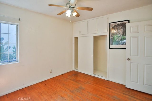 2851 Webster Ave, Long Beach, CA 90810 - unfurnished bedroom featuring light wood-type flooring, a closet, baseboards, and ceiling fan