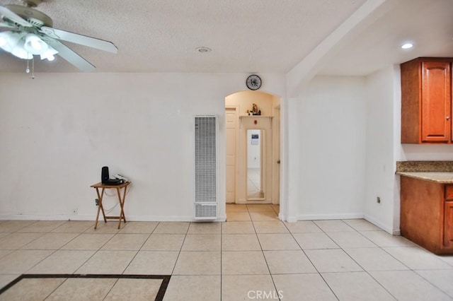 2851 Webster Ave, Long Beach, CA 90810 - kitchen featuring a heating unit, ceiling fan, arched walkways, light tile patterned floors, and recessed lighting