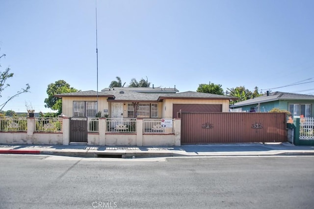 2851 Webster Ave, Long Beach, CA 90810 - view of front of home with a fenced front yard, a garage, and a gate