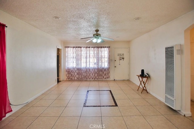 2851 Webster Ave, Long Beach, CA 90810 - unfurnished room featuring a heating unit, ceiling fan, a textured ceiling, light tile patterned floors, and baseboards
