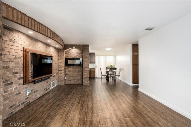 25176 Wendy Way, Moreno Valley, CA 92551 - living area with dark wood-type flooring, baseboards, and brick wall
