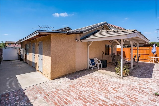 25176 Wendy Way, Moreno Valley, CA 92551 - view of home's exterior featuring stucco siding, a patio, a gate, and a tile roof