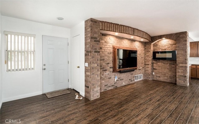 25176 Wendy Way, Moreno Valley, CA 92551 - unfurnished living room featuring dark wood finished floors, baseboards, and brick wall