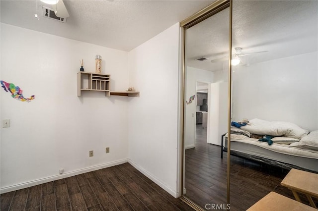 25176 Wendy Way, Moreno Valley, CA 92551 - bedroom with dark wood-style flooring, baseboards, ceiling fan, and a textured ceiling