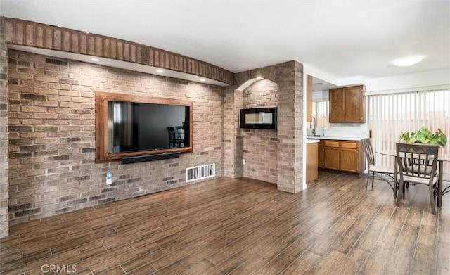 25176 Wendy Way, Moreno Valley, CA 92551 - living area featuring dark wood-style floors and brick wall