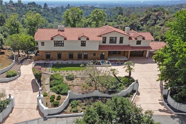 view from above of property featuring a heavily wooded area