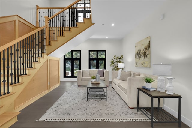 living area featuring baseboards, stairs, recessed lighting, and wood finished floors