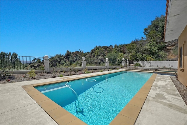 view of swimming pool with fence