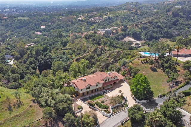 aerial overview of property's location with a heavily wooded area