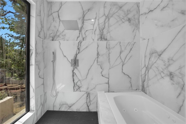 bathroom featuring a whirlpool tub and a marble finish shower