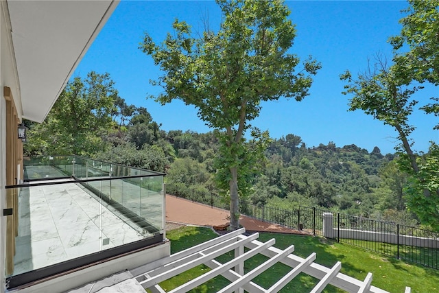 balcony featuring a view of trees