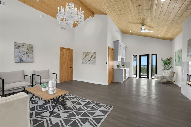 living area with high vaulted ceiling, wooden ceiling, dark wood-style floors, a chandelier, and baseboards