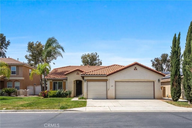 225 Caldera Ln, Hemet, CA 92545 - mediterranean / spanish-style home featuring an attached garage, concrete driveway, stucco siding, a tiled roof, and a front lawn