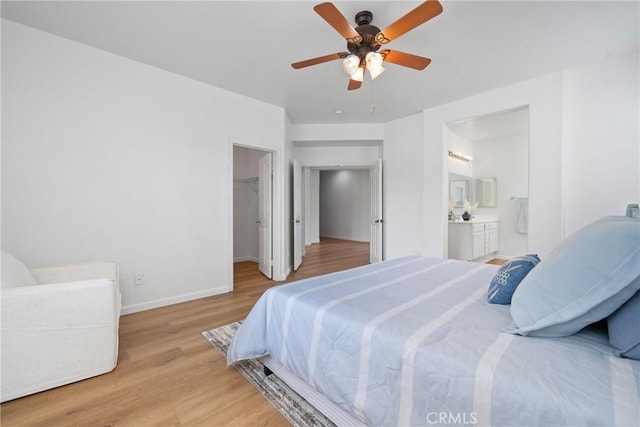 225 Caldera Ln, Hemet, CA 92545 - bedroom with light wood-style flooring, a spacious closet, baseboards, ensuite bathroom, and a ceiling fan
