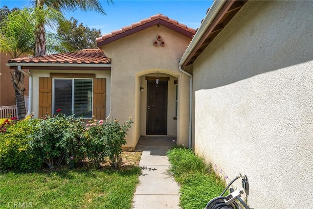 225 Caldera Ln, Hemet, CA 92545 - view of exterior entry featuring stucco siding and a tile roof