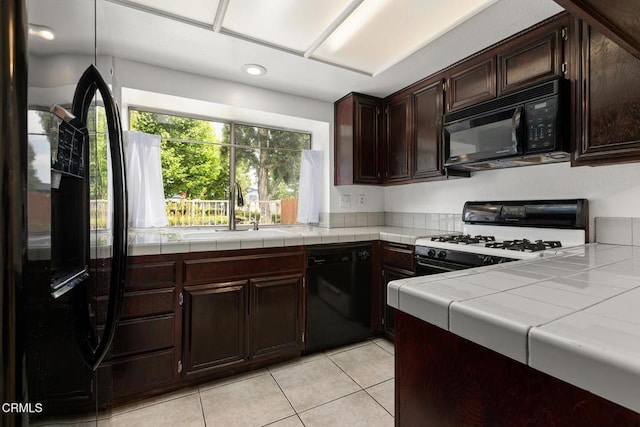 817 Copper Privado, Ontario, CA 91762 - kitchen featuring black appliances, light tile patterned floors, tile countertops, a sink, and dark brown cabinetry