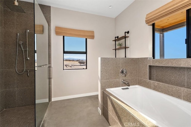 full bathroom with a walk in shower, baseboards, a garden tub, and concrete floors