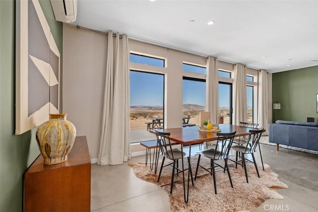 dining space featuring concrete flooring, plenty of natural light, recessed lighting, and a wall mounted AC