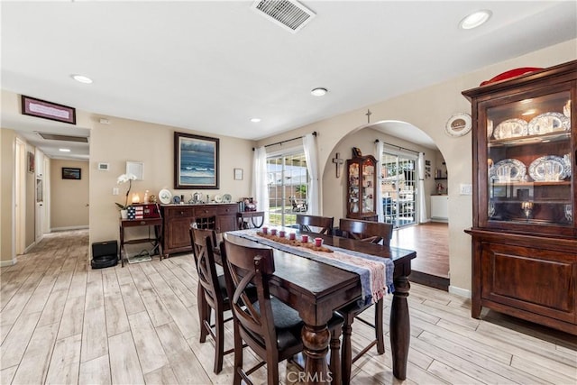 5471 Santa Gertrudes Ave, Garden Grove, CA 92845 - dining space featuring light wood-style flooring, arched walkways, recessed lighting, and baseboards