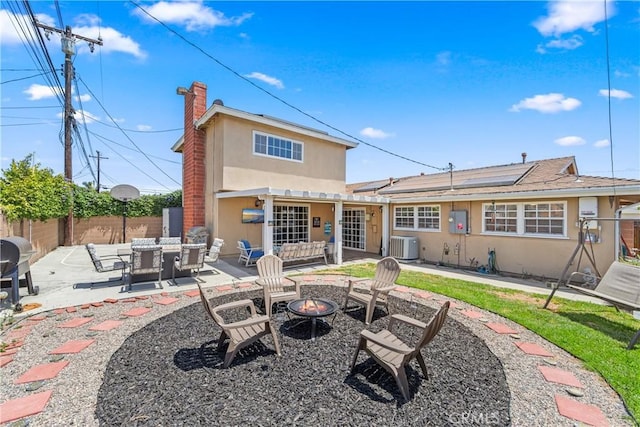 5471 Santa Gertrudes Ave, Garden Grove, CA 92845 - rear view of property with an outdoor fire pit, stucco siding, a patio, a fenced backyard, and solar panels