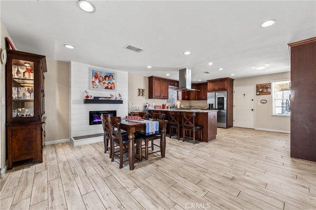 5471 Santa Gertrudes Ave, Garden Grove, CA 92845 - dining room with light wood-style flooring, baseboards, a glass covered fireplace, and recessed lighting