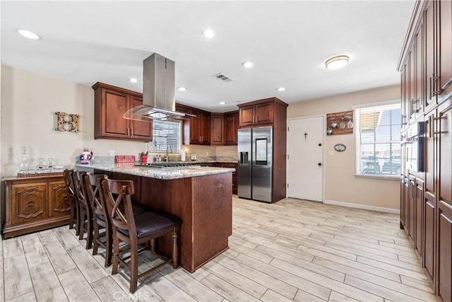 5471 Santa Gertrudes Ave, Garden Grove, CA 92845 - kitchen featuring stainless steel refrigerator with ice dispenser, island range hood, a peninsula, light wood-style flooring, and recessed lighting