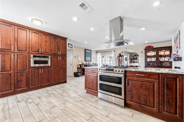 5471 Santa Gertrudes Ave, Garden Grove, CA 92845 - kitchen with stainless steel appliances, arched walkways, island exhaust hood, light wood finished floors, and light stone counters