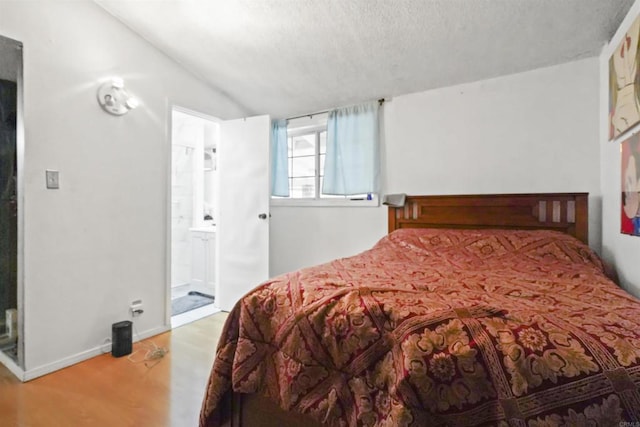 17010 Pocono St, La Puente, CA 91744 - bedroom with lofted ceiling, wood finished floors, a textured ceiling, and ensuite bathroom