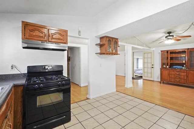 17010 Pocono St, La Puente, CA 91744 - kitchen featuring under cabinet range hood, black gas range oven, vaulted ceiling, a ceiling fan, and dark countertops