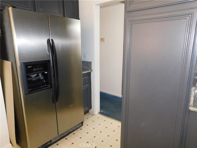 10755 Jasper Ave, Redlands, CA 92374 - kitchen with stainless steel fridge, light flooring, gray cabinets, and baseboards