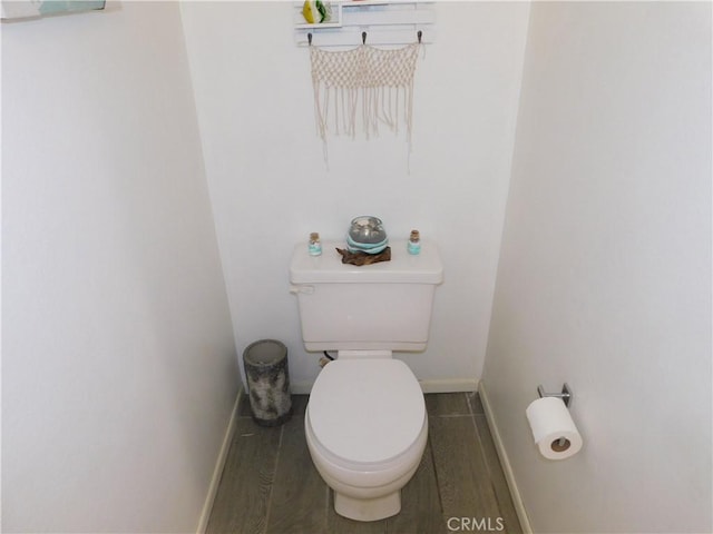 10755 Jasper Ave, Redlands, CA 92374 - bathroom featuring baseboards, toilet, and wood finished floors