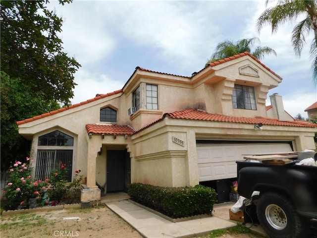 10755 Jasper Ave, Redlands, CA 92374 - mediterranean / spanish home featuring a tiled roof, stucco siding, and a garage