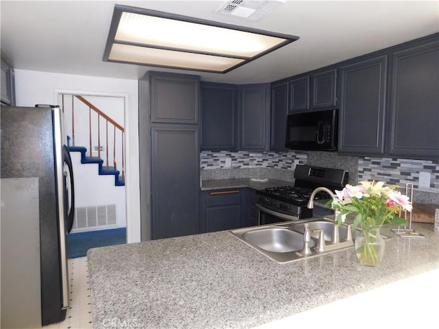 10755 Jasper Ave, Redlands, CA 92374 - kitchen featuring black microwave, freestanding refrigerator, stainless steel range with gas cooktop, and decorative backsplash