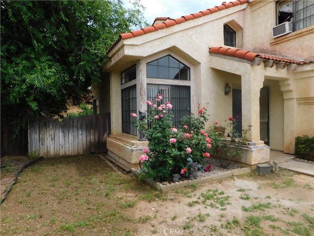 10755 Jasper Ave, Redlands, CA 92374 - back of property featuring a tile roof, fence, stucco siding, and cooling unit