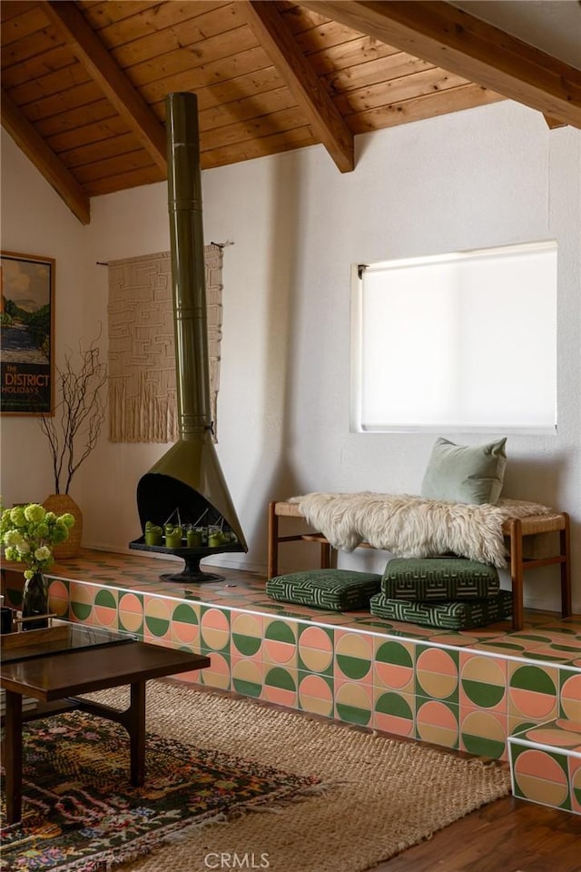 living area featuring wooden ceiling, wood finished floors, and a wood stove