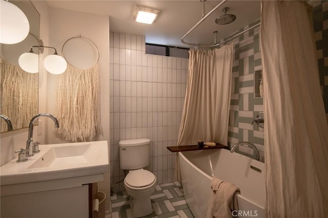 bathroom with shower / tub combo, toilet, vanity, tile walls, and tile patterned flooring