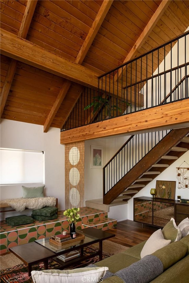 living room with wooden ceiling, beam ceiling, wood finished floors, stairway, and high vaulted ceiling