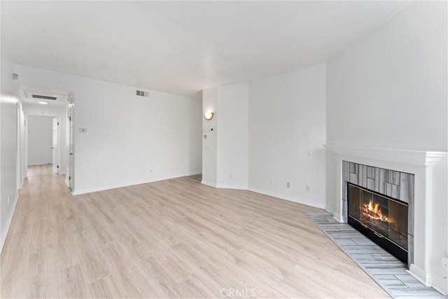 21848 S Vermont Ave Unit 6, Torrance, CA 90502 - unfurnished living room featuring light wood-type flooring and a fireplace