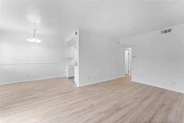 21848 S Vermont Ave Unit 6, Torrance, CA 90502 - unfurnished living room featuring a chandelier and light wood-type flooring