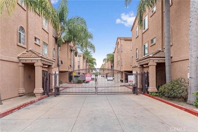 21848 S Vermont Ave Unit 6, Torrance, CA 90502 - view of concrete road with a gate, curbs, a gated entry, and a residential view