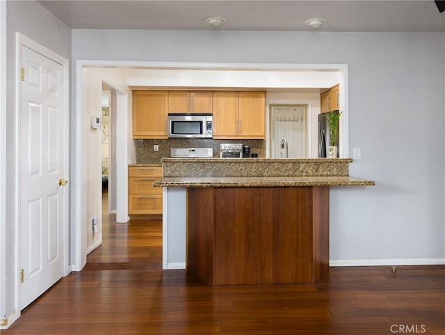 22305 Ladeene Ave, Torrance, CA 90505 - kitchen featuring stainless steel microwave, a peninsula, tasteful backsplash, range, and stone countertops