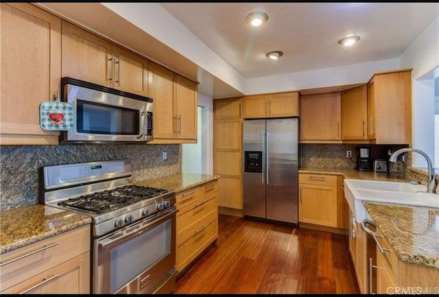 22305 Ladeene Ave, Torrance, CA 90505 - kitchen with stainless steel appliances, dark wood-type flooring, a sink, and light stone countertops