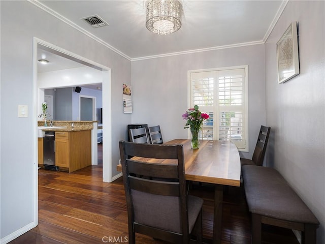 22305 Ladeene Ave, Torrance, CA 90505 - dining area with a chandelier, dark wood-style flooring, crown molding, and baseboards