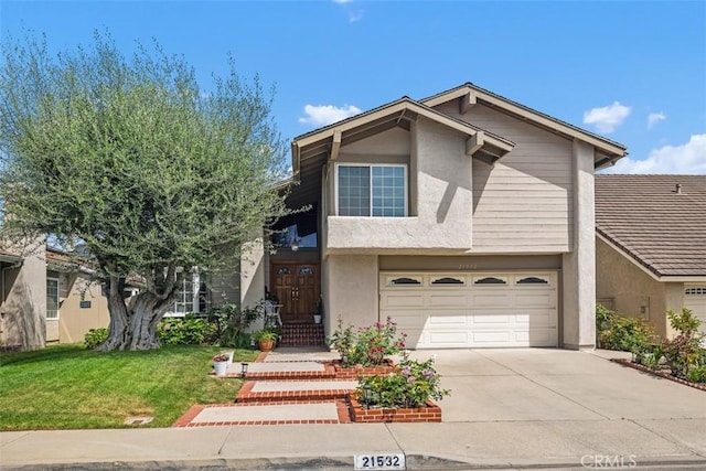 21532 Camino Papal, Lake Forest, CA 92630 - view of front of house with stucco siding, an attached garage, driveway, and a front yard