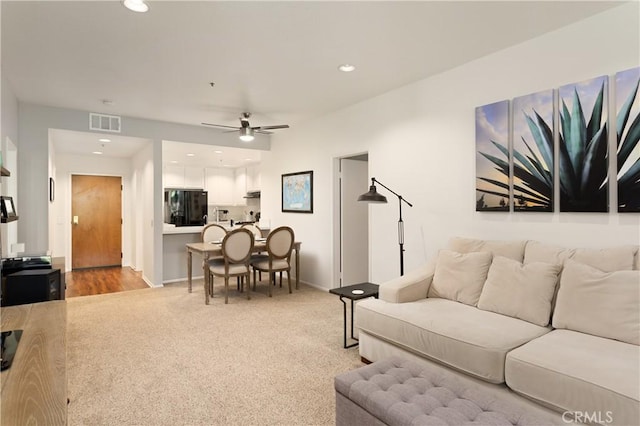 270 Cagney Ln Unit 215, Newport Beach, CA 92663 - living room with light carpet, a ceiling fan, recessed lighting, and baseboards