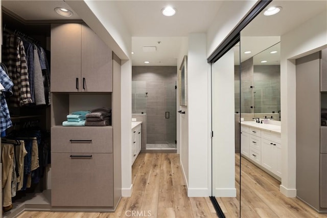 270 Cagney Ln Unit 215, Newport Beach, CA 92663 - full bathroom featuring vanity, a shower stall, wood finished floors, and recessed lighting