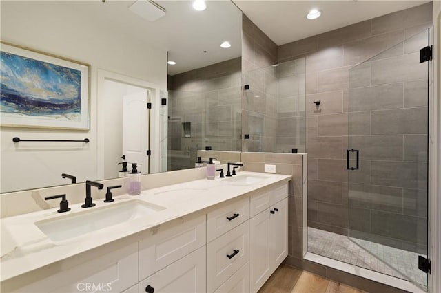 270 Cagney Ln Unit 215, Newport Beach, CA 92663 - bathroom with a shower stall, double vanity, recessed lighting, and wood finished floors